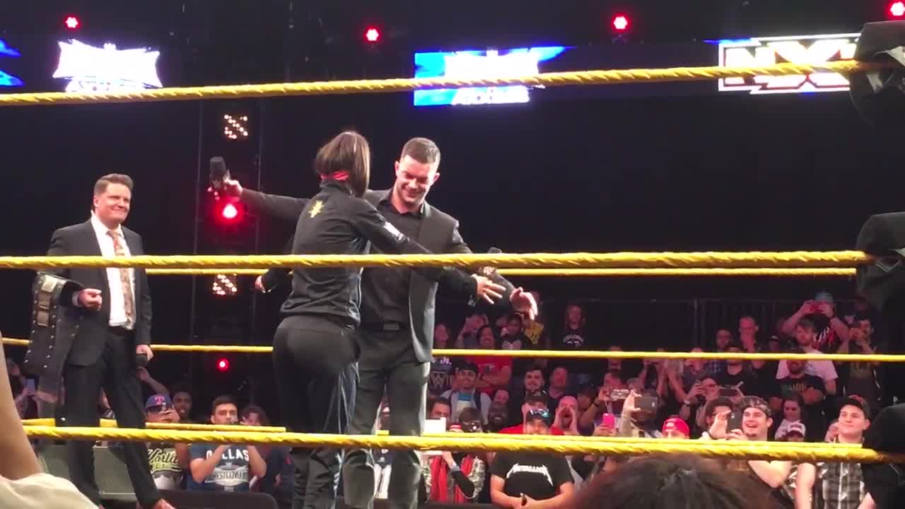 Finn Balor and Bayley hug at WWE AXXESS event